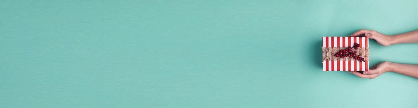 Two hands holding a red and white striped box on a blue background.