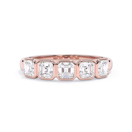 A picture of a five stone diamond wedding ring with asscher shape diamonds that are bezel set in rose gold on a white background with the ring facing forward, lying down.