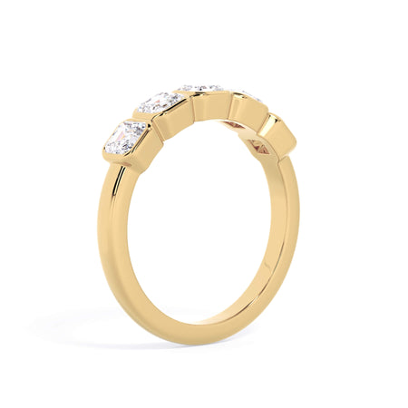 A picture of a five stone diamond wedding ring with asscher shape diamonds that are bezel set in yellow gold on a white background with a slightly angled, through the finger view.
