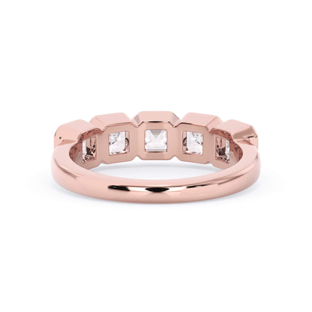 A picture of a five stone diamond wedding ring with asscher shape diamonds that are bezel set in rose gold on a white background with a view of the underside of the ring.