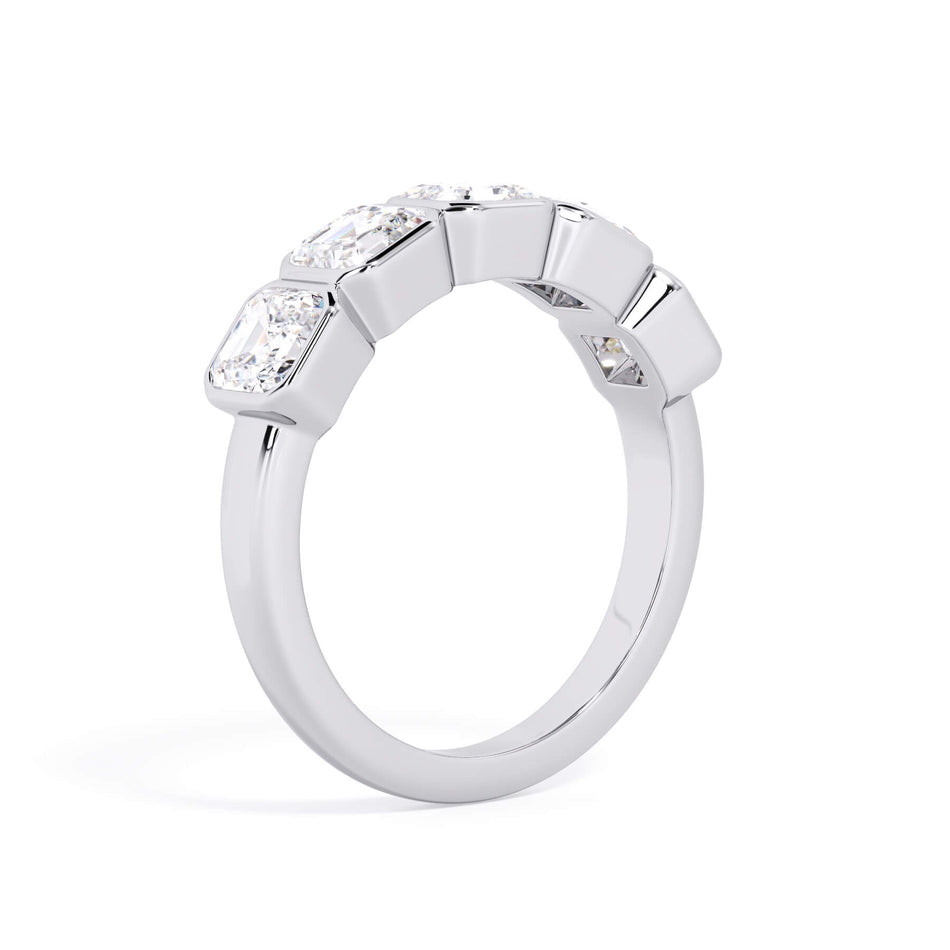 A picture of a five stone diamond wedding ring with asscher shape diamonds that are bezel set in white gold or platinum on a white background with a slightly angled, through the finger view.