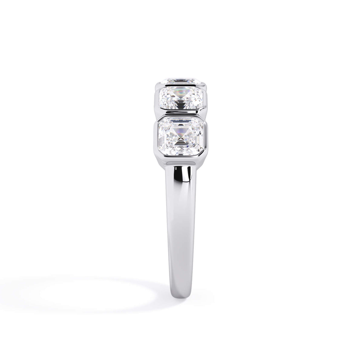 A picture of a five stone diamond wedding ring with asscher shape diamonds that are bezel set in white gold or platinum on a white background with a side profile view.