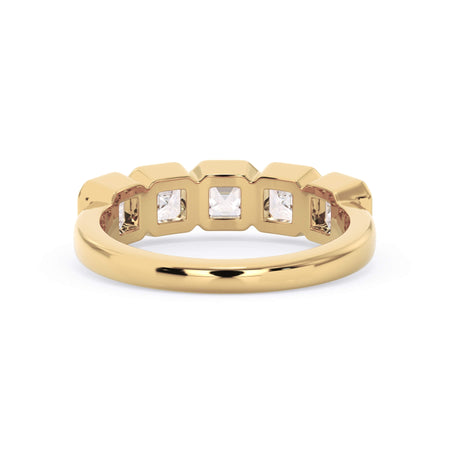 A picture of a five stone diamond wedding ring with asscher shape diamonds that are bezel set in yellow gold on a white background with a view of the underside of the ring.