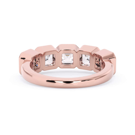 A picture of a five stone diamond wedding ring with asscher shape diamonds that are bezel set in rose gold on a white background with a view of the underside of the ring.
