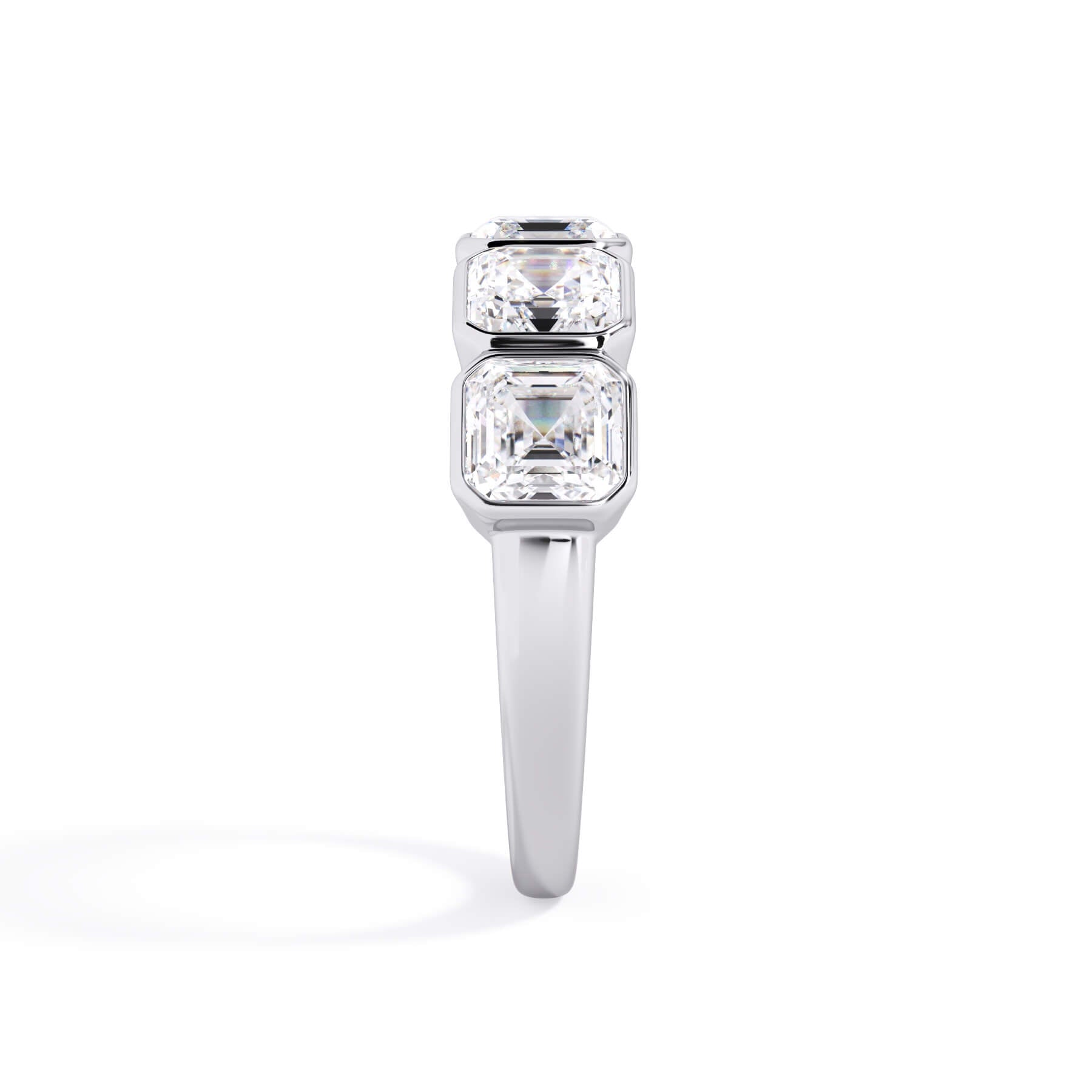 A picture of a five stone diamond wedding ring with asscher shape diamonds that are bezel set in white gold or platinum on a white background with a side profile view.