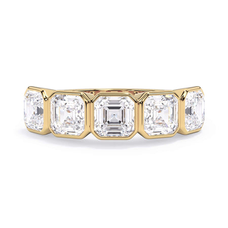 A picture of a five stone diamond wedding ring with asscher shape diamonds that are bezel set in yellow gold on a white background with the ring facing forward, lying down.