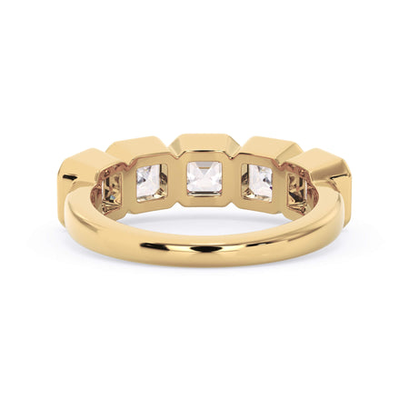 A picture of a five stone diamond wedding ring with asscher shape diamonds that are bezel set in yellow gold on a white background with a view of the underside of the ring.