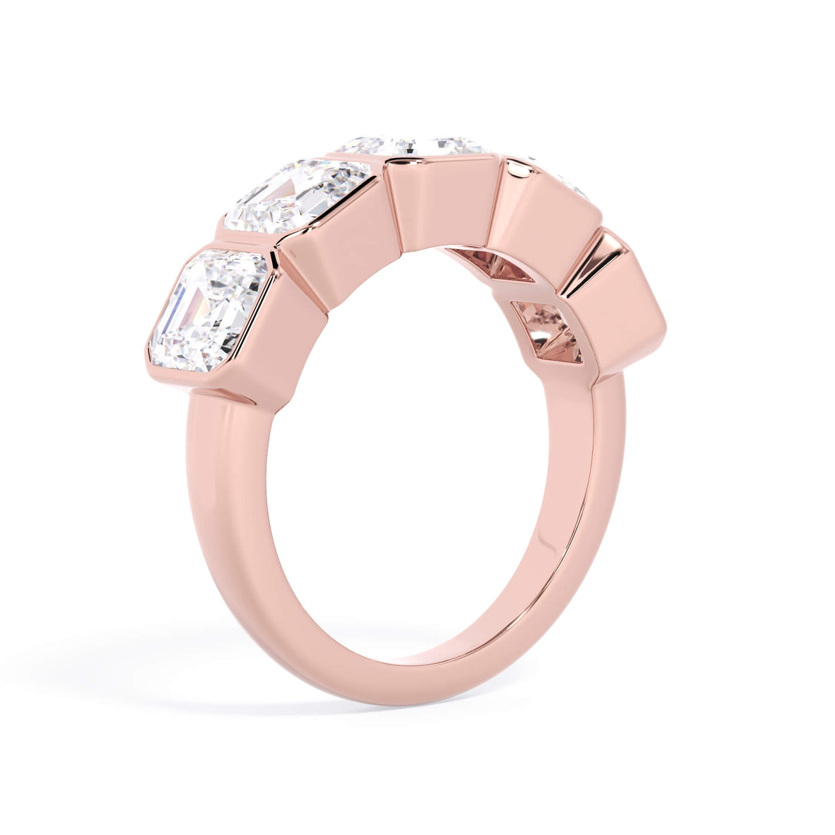 A picture of a five stone diamond wedding ring with asscher shape diamonds that are bezel set in rose gold on a white background with a slightly angled, through the finger view.