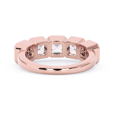 A picture of a five stone diamond wedding ring with asscher shape diamonds that are bezel set in rose gold on a white background with a view of the underside of the ring.