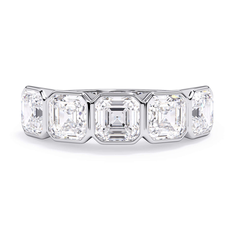 A picture of a five stone diamond wedding ring with asscher shape diamonds that are bezel set in white gold or platinum on a white background with the ring facing forward, lying down.