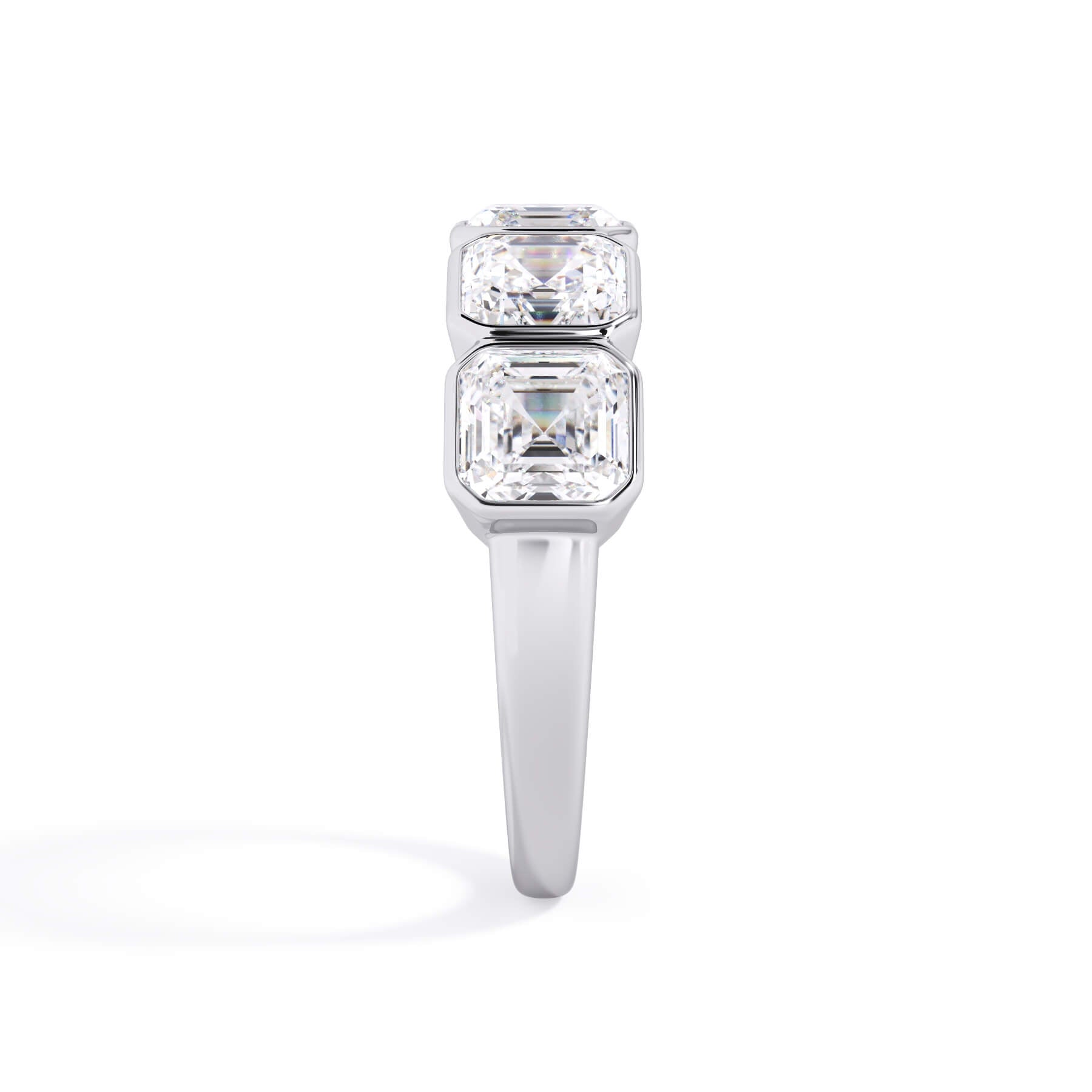 A picture of a five stone diamond wedding ring with asscher shape diamonds that are bezel set in white gold or platinum on a white background with a side profile view.