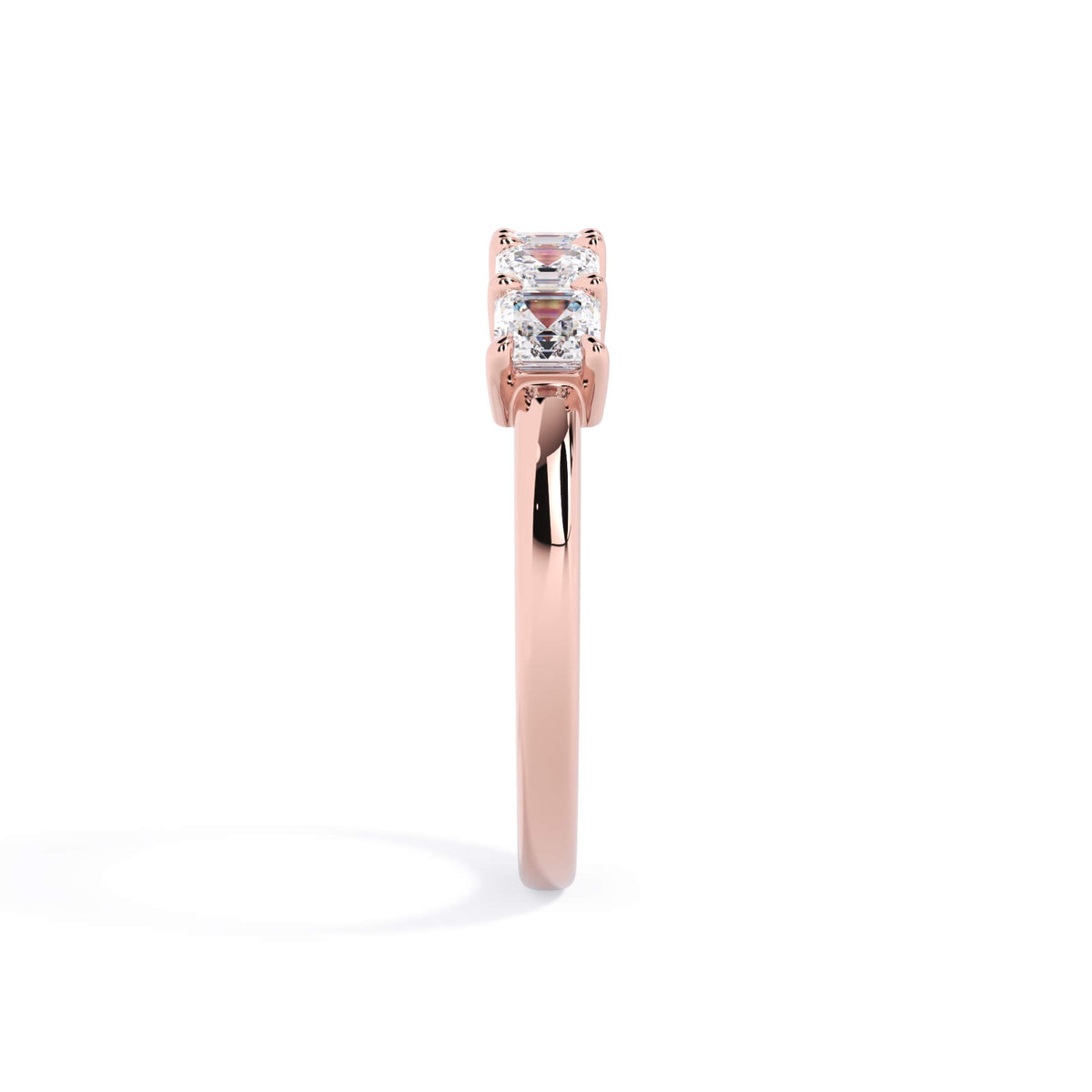 A picture of a five stone diamond wedding ring with asscher shape diamonds that are shared prong set in rose gold on a white background with a side profile view.