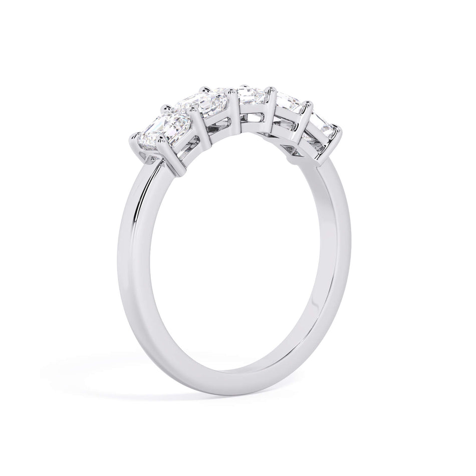 A picture of a five stone diamond wedding ring with asscher shape diamonds that are shared prong set in white gold or platinum on a white background with a slightly angled, through the finger view.