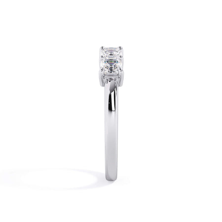 A picture of a five stone diamond wedding ring with asscher shape diamonds that are shared prong set in white gold or platinum on a white background with a side profile view.