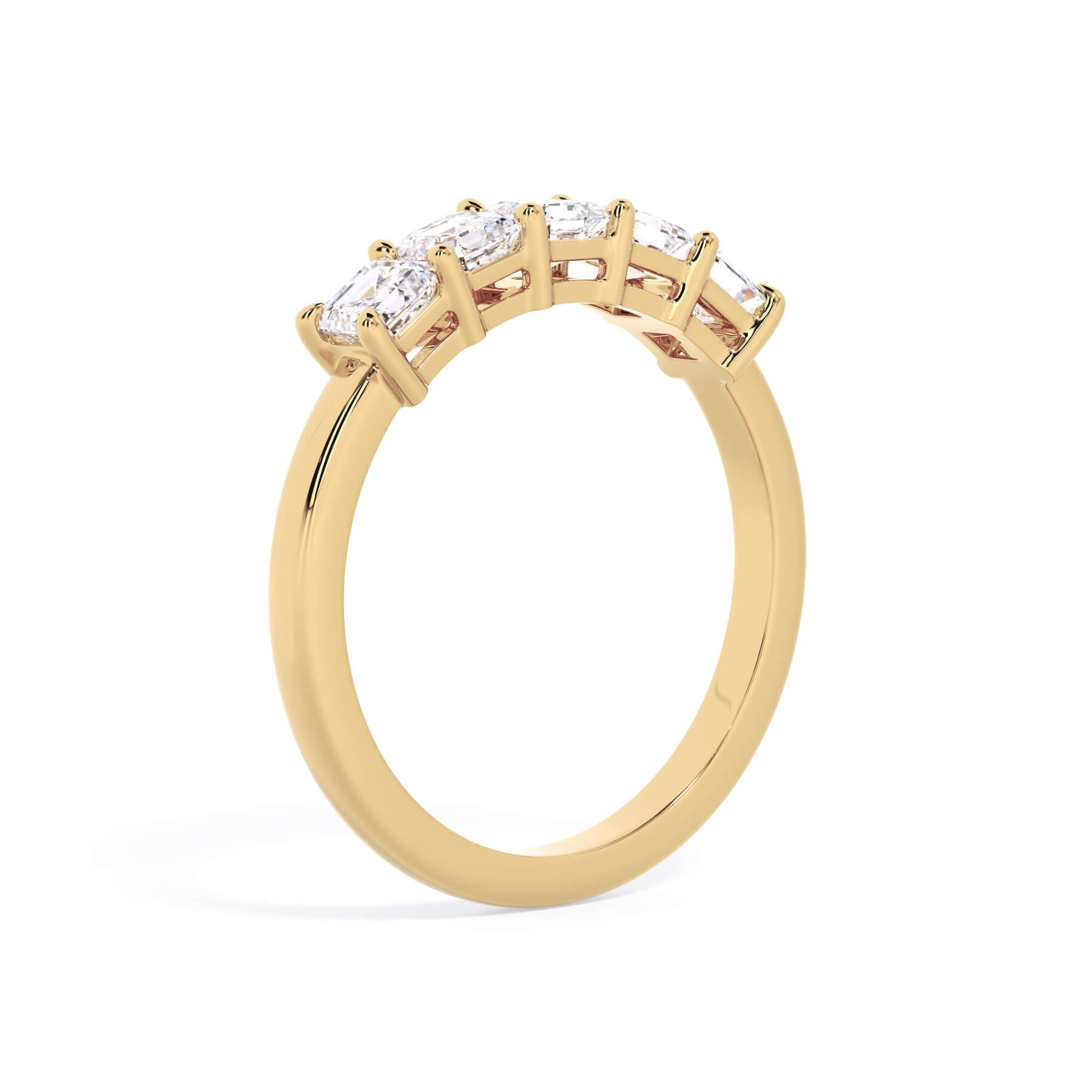 A picture of a five stone diamond wedding ring with asscher shape diamonds that are shared prong set in yellow gold on a white background with a slightly angled, through the finger view.