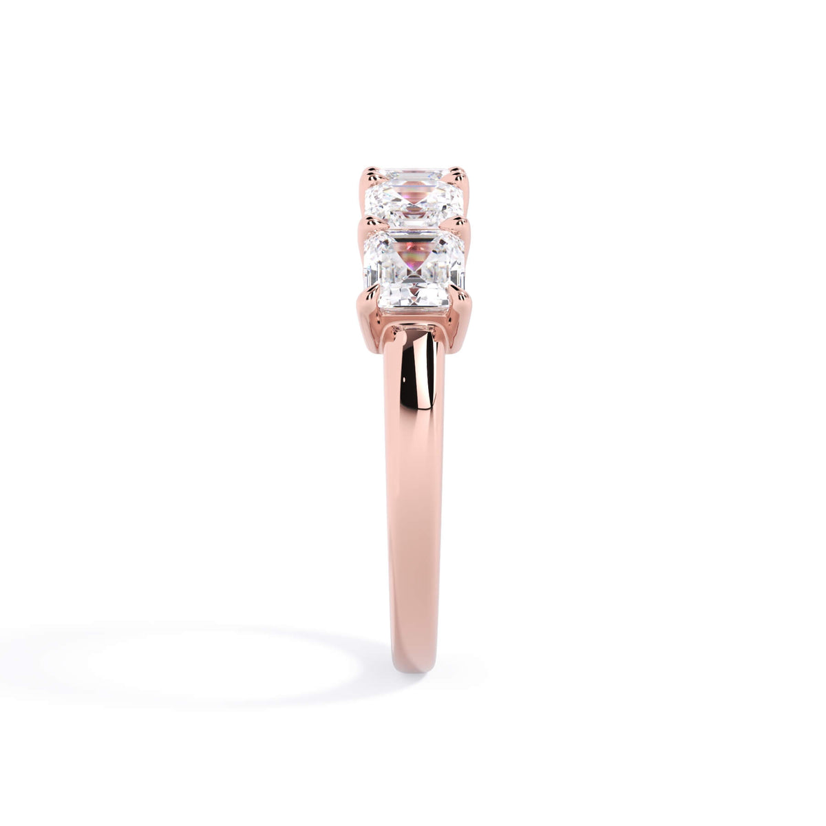 A picture of a five stone diamond wedding ring with asscher shape diamonds that are shared prong set in rose gold on a white background with a side profile view.