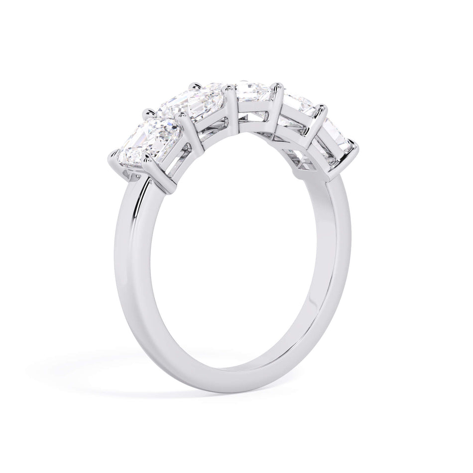 A picture of a five stone diamond wedding ring with asscher shape diamonds that are shared prong set in white gold or platinum on a white background with a slightly angled, through the finger view.