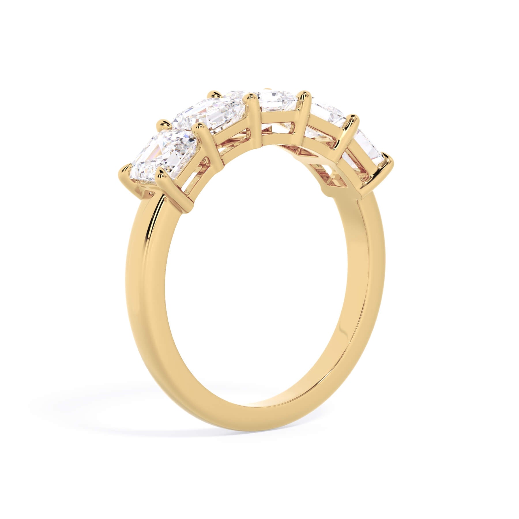 A picture of a five stone diamond wedding ring with asscher shape diamonds that are shared prong set in yellow gold on a white background with a slightly angled, through the finger view.