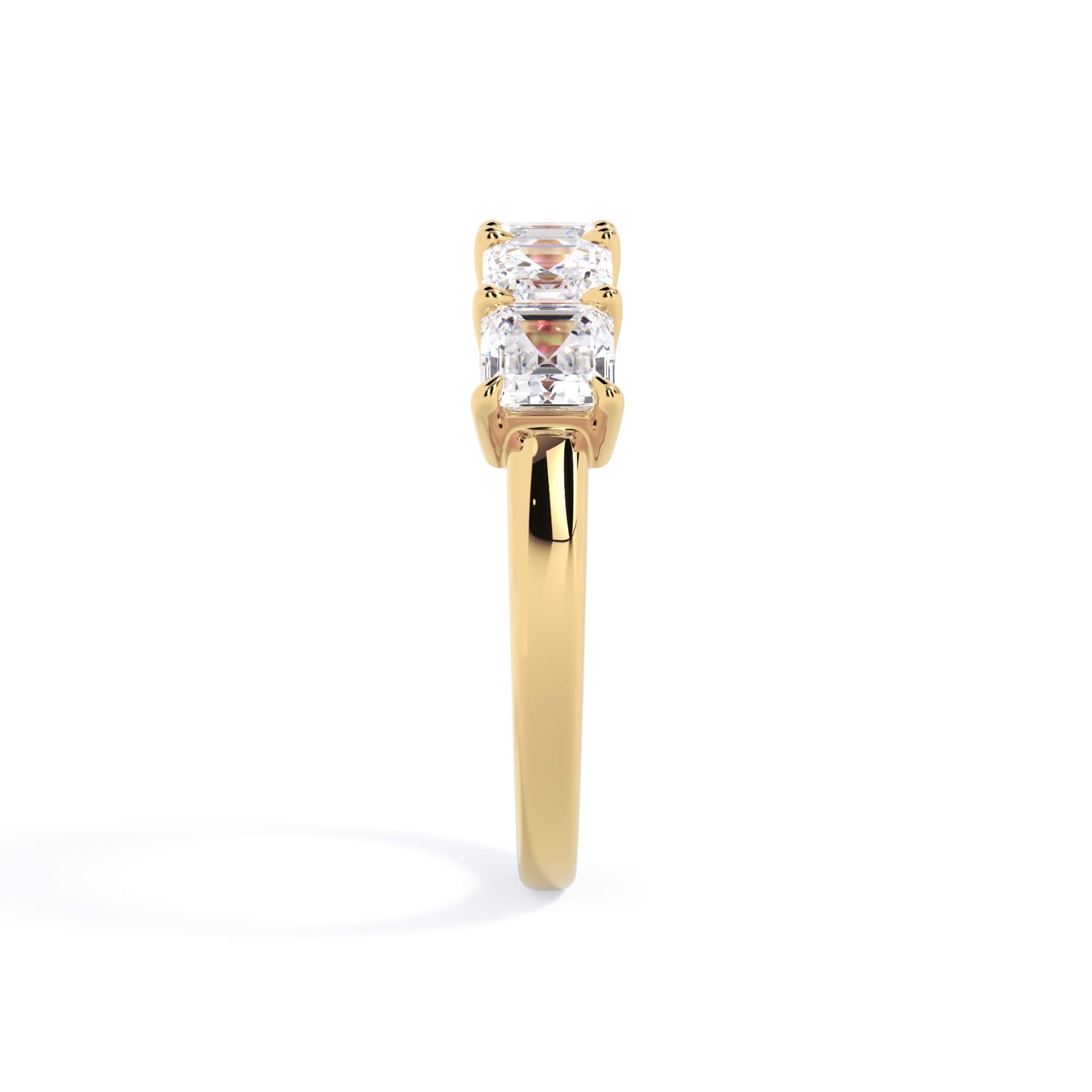A picture of a five stone diamond wedding ring with asscher shape diamonds that are shared prong set in yellow gold on a white background with a side profile view.