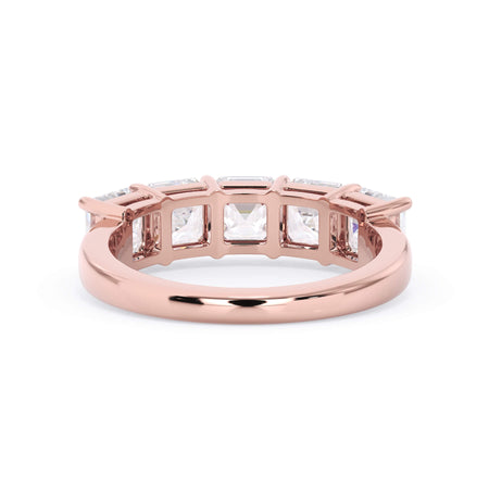 A picture of a five stone diamond wedding ring with asscher shape diamonds that are shared prong set in rose gold on a white background with a view of the underside of the ring.