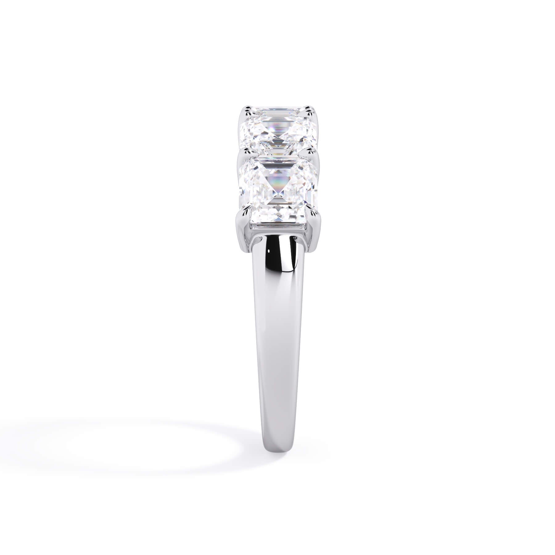 A picture of a five stone diamond wedding ring with asscher shape diamonds that are shared prong set in white gold or platinum on a white background with a side profile view.