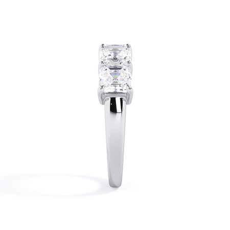 A picture of a five stone diamond wedding ring with asscher shape diamonds that are shared prong set in white gold or platinum on a white background with a side profile view.