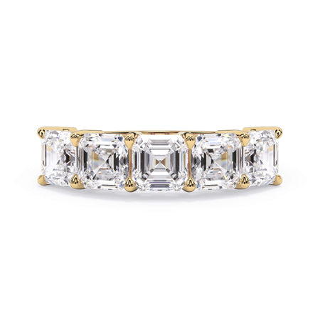 A picture of a five stone diamond wedding ring with asscher shape diamonds that are shared prong set in yellow gold on a white background with the ring facing forward, lying down.