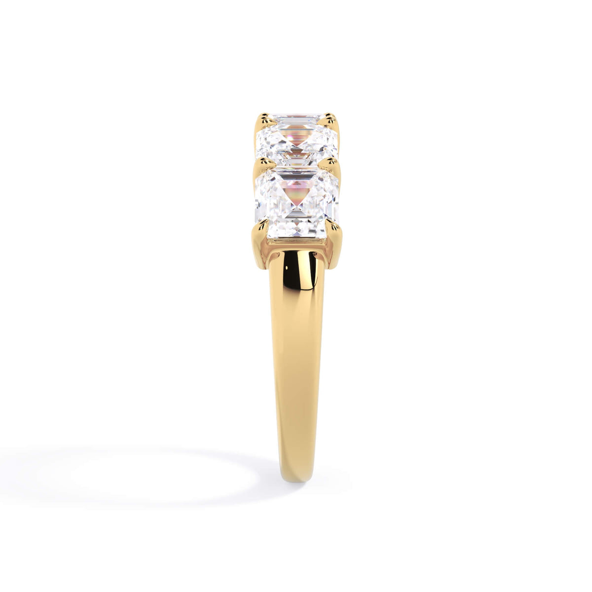 A picture of a five stone diamond wedding ring with asscher shape diamonds that are shared prong set in yellow gold on a white background with a side profile view.