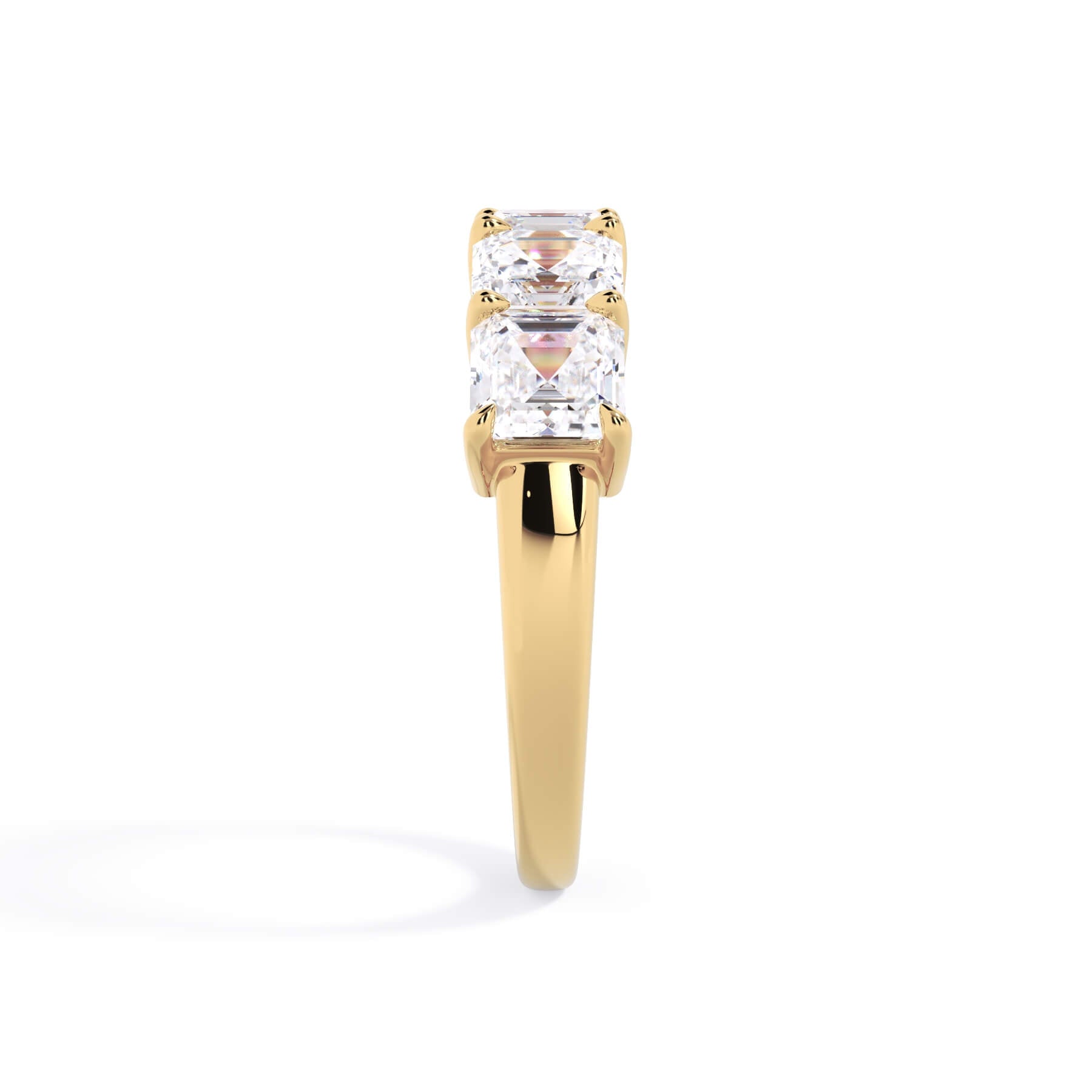 A picture of a five stone diamond wedding ring with asscher shape diamonds that are shared prong set in yellow gold on a white background with a side profile view.