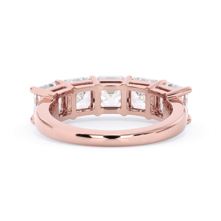A picture of a five stone diamond wedding ring with asscher shape diamonds that are shared prong set in rose gold on a white background with a view of the underside of the ring.