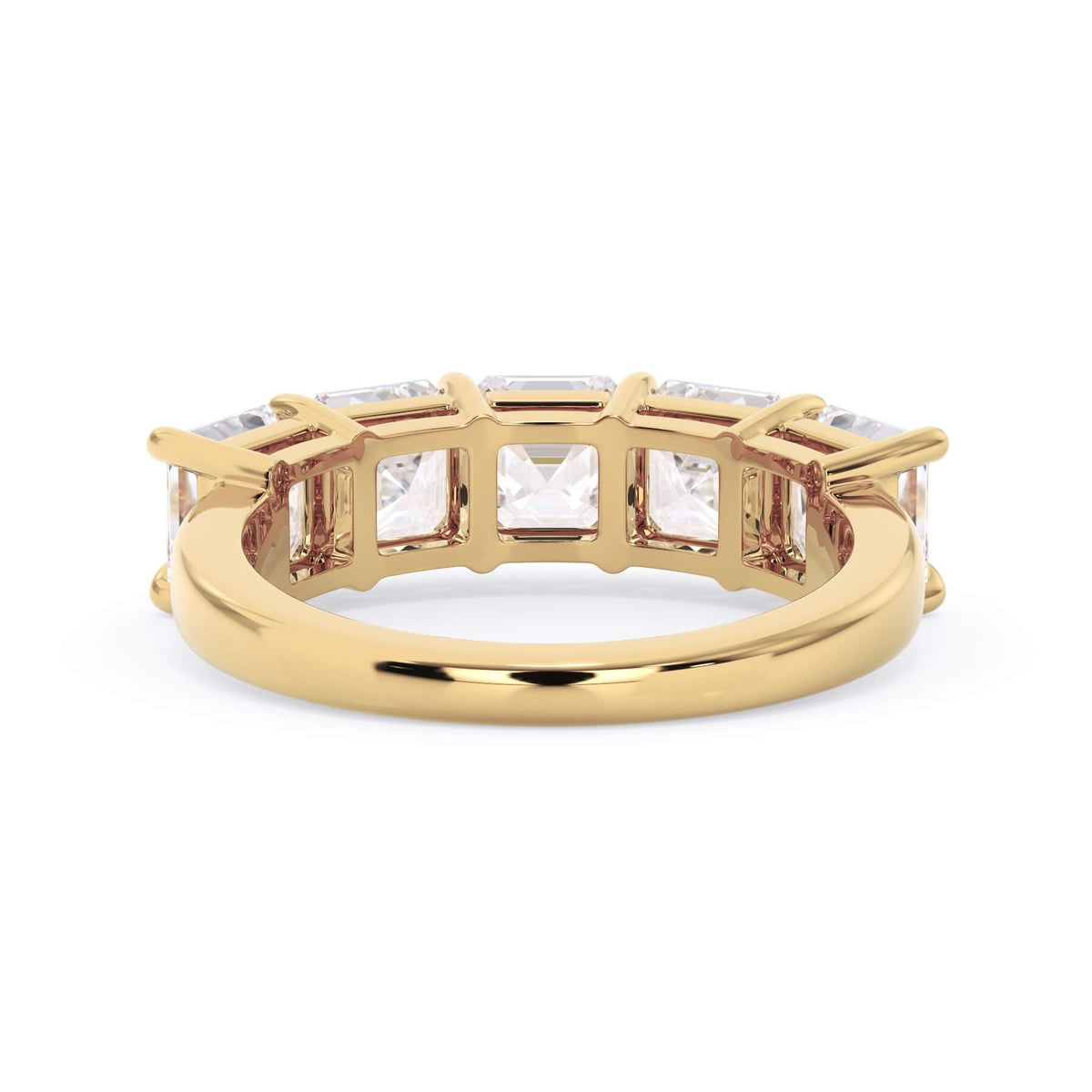 A picture of a five stone diamond wedding ring with asscher shape diamonds that are shared prong set in yellow gold on a white background with a view of the underside of the ring.