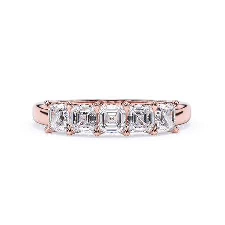 A picture of a five stone diamond wedding ring with asscher shape diamonds that are u prong set in rose gold on a white background with the ring facing forward, lying down.