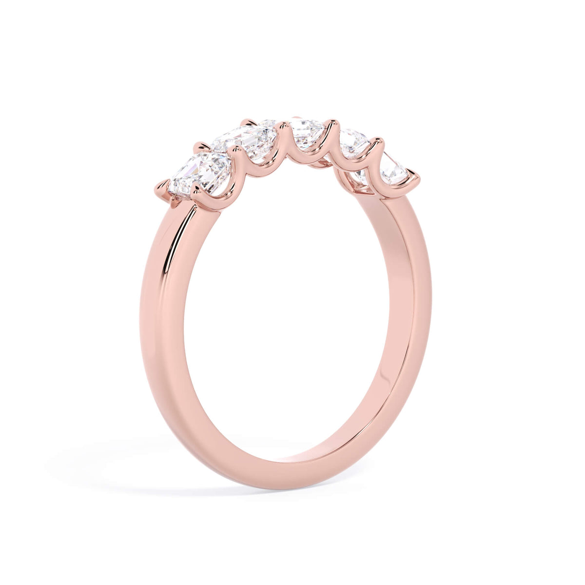 A picture of a five stone diamond wedding ring with asscher shape diamonds that are u prong set in rose gold on a white background with a slightly angled, through the finger view.