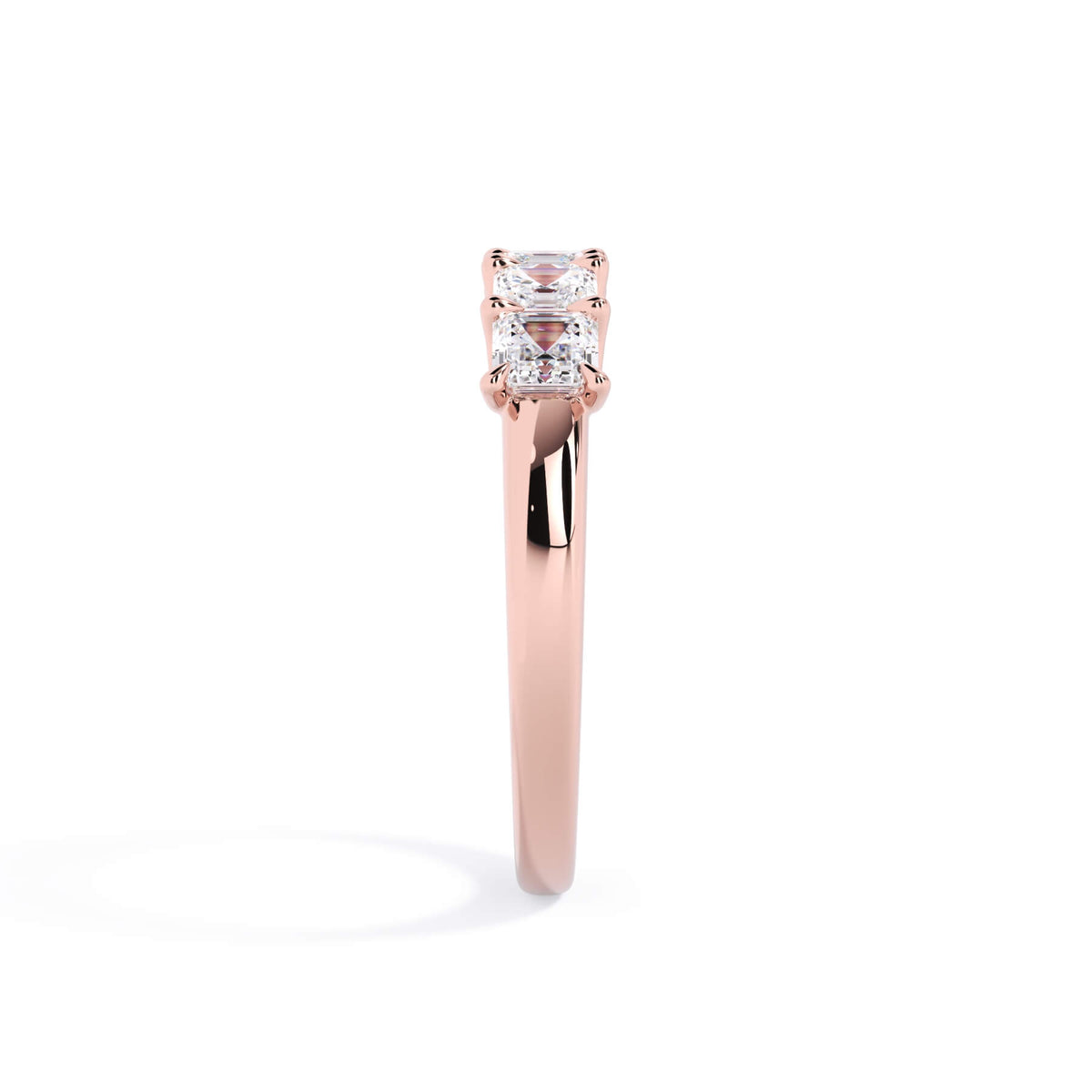 A picture of a five stone diamond wedding ring with asscher shape diamonds that are u prong set in rose gold on a white background with a side profile view.