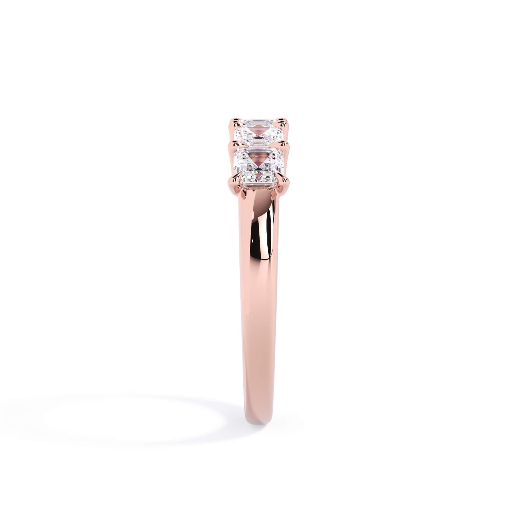 A picture of a five stone diamond wedding ring with asscher shape diamonds that are u prong set in rose gold on a white background with a side profile view.