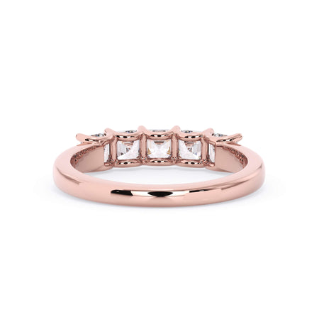 A picture of a five stone diamond wedding ring with asscher shape diamonds that are u prong set in rose gold on a white background with a view of the underside of the ring.