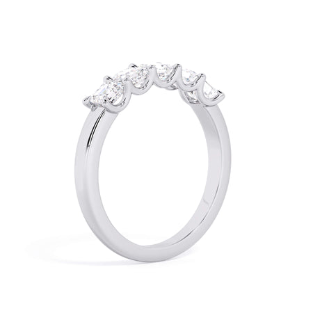 A picture of a five stone diamond wedding ring with asscher shape diamonds that are u prong set in white gold or platinum on a white background with a slightly angled, through the finger view.