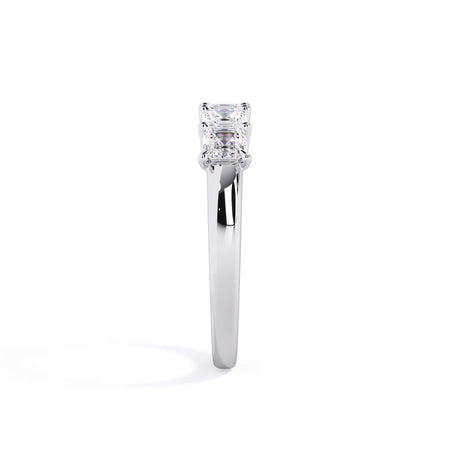 A picture of a five stone diamond wedding ring with asscher shape diamonds that are u prong set in white gold or platinum on a white background with a side profile view.