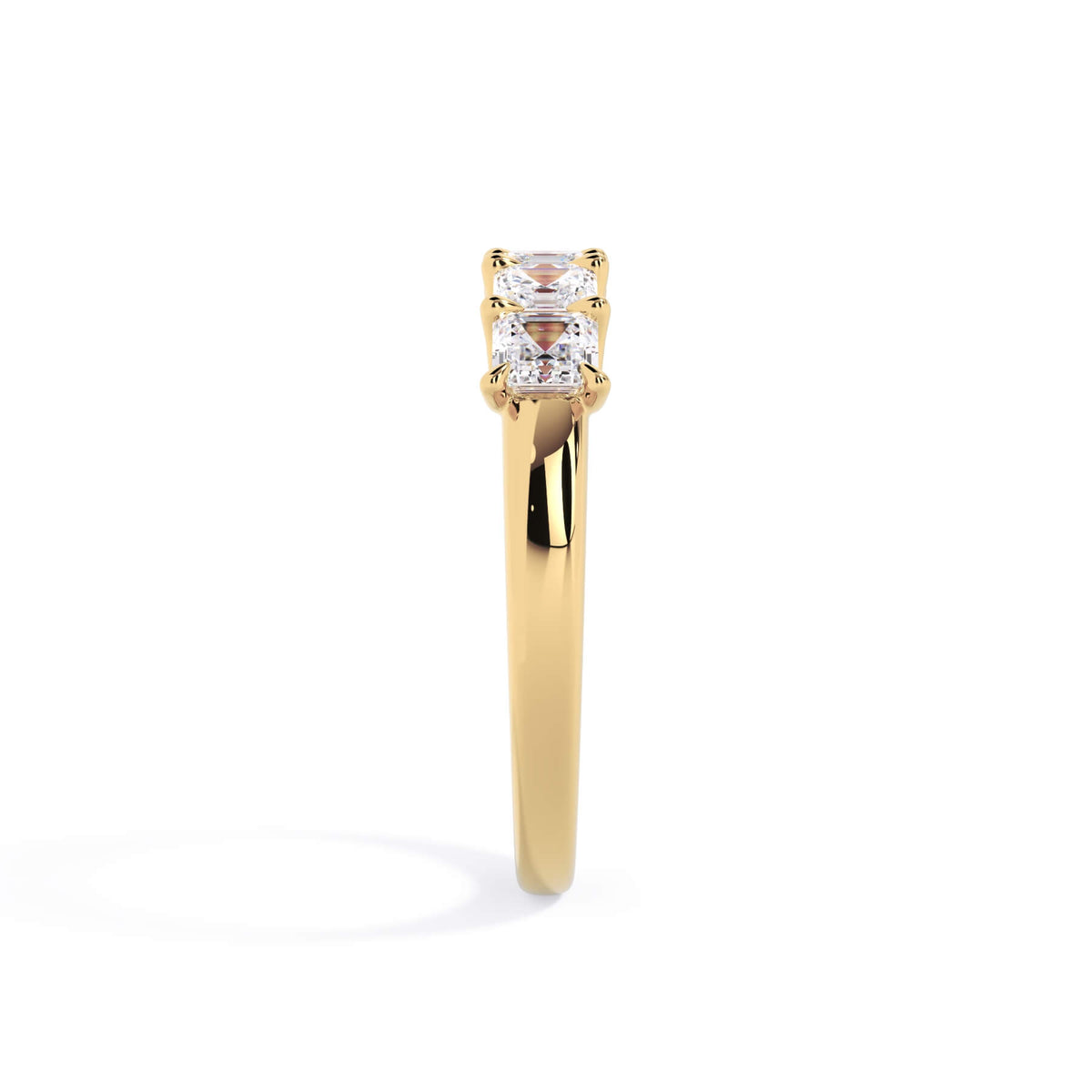 A picture of a five stone diamond wedding ring with asscher shape diamonds that are u prong set in yellow gold on a white background with a side profile view.