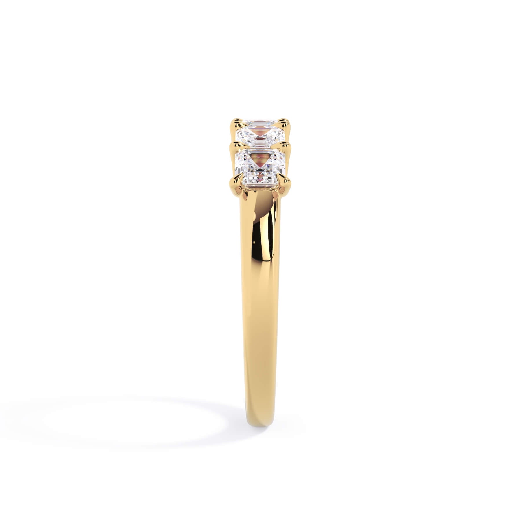 A picture of a five stone diamond wedding ring with asscher shape diamonds that are u prong set in yellow gold on a white background with a side profile view.