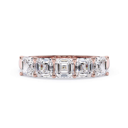 A picture of a five stone diamond wedding ring with asscher shape diamonds that are u prong set in rose gold on a white background with the ring facing forward, lying down.