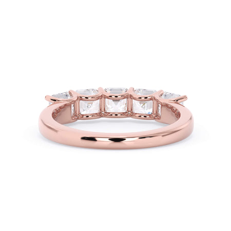 A picture of a five stone diamond wedding ring with asscher shape diamonds that are u prong set in rose gold on a white background with a view of the underside of the ring.