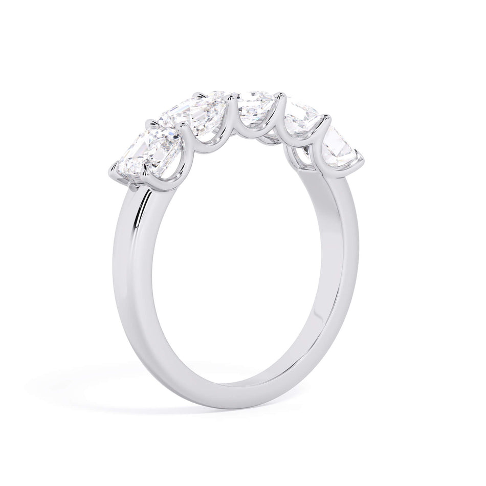 A picture of a five stone diamond wedding ring with asscher shape diamonds that are u prong set in white gold or platinum on a white background with a slightly angled, through the finger view.