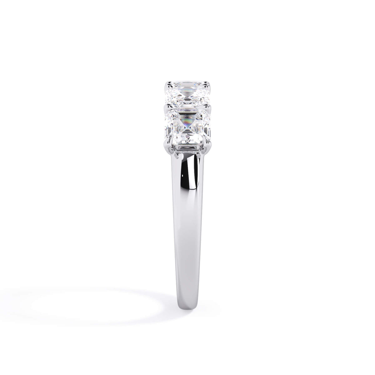 A picture of a five stone diamond wedding ring with asscher shape diamonds that are u prong set in white gold or platinum on a white background with a side profile view.