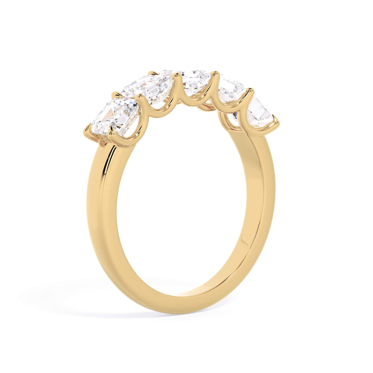 A picture of a five stone diamond wedding ring with asscher shape diamonds that are u prong set in yellow gold on a white background with a slightly angled, through the finger view.