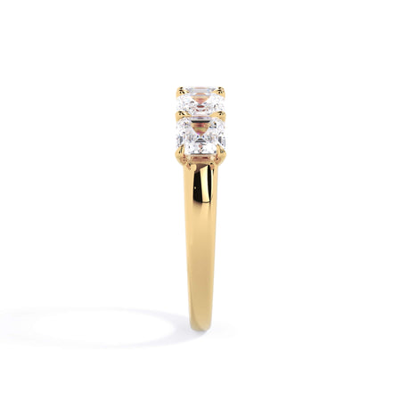 A picture of a five stone diamond wedding ring with asscher shape diamonds that are u prong set in yellow gold on a white background with a side profile view.