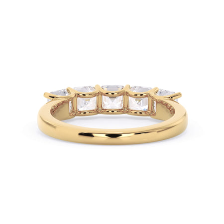 A picture of a five stone diamond wedding ring with asscher shape diamonds that are u prong set in yellow gold on a white background with a view of the underside of the ring.