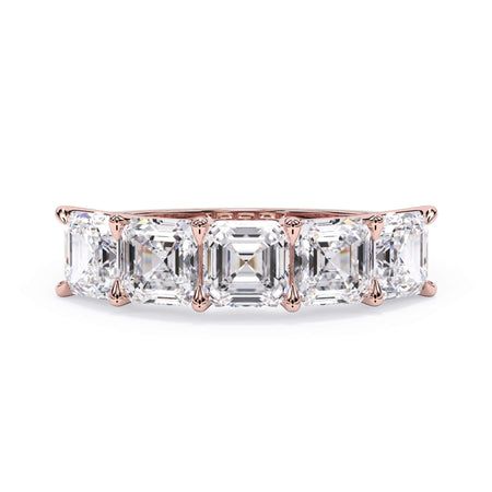 A picture of a five stone diamond wedding ring with asscher shape diamonds that are u prong set in rose gold on a white background with the ring facing forward, lying down.