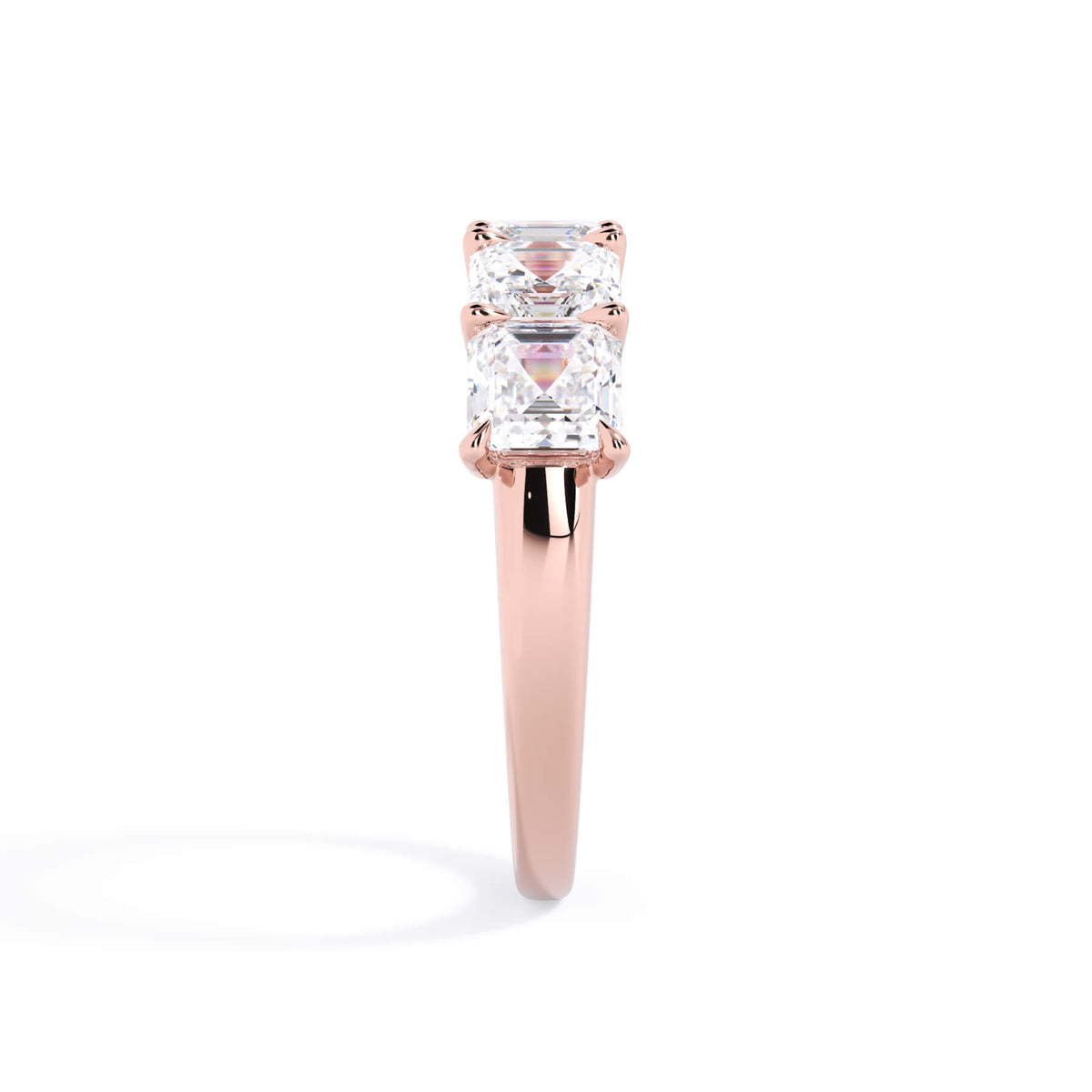 A picture of a five stone diamond wedding ring with asscher shape diamonds that are u prong set in rose gold on a white background with a side profile view.
