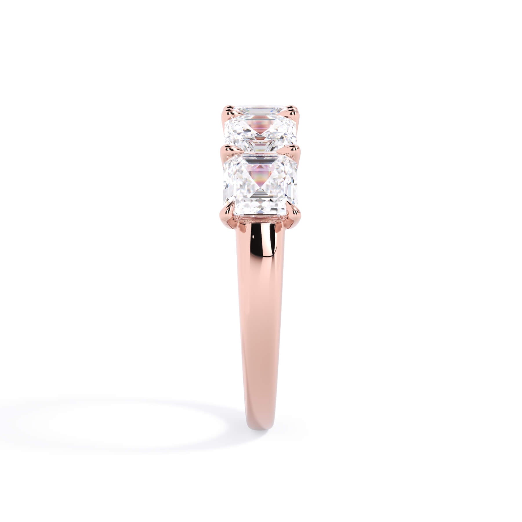 A picture of a five stone diamond wedding ring with asscher shape diamonds that are u prong set in rose gold on a white background with a side profile view.